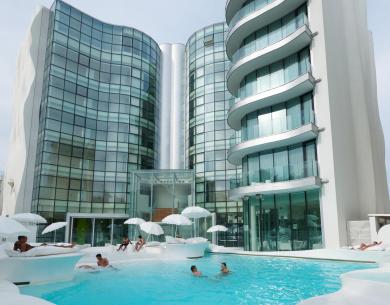 Modern hotel with pool and elegant architecture.