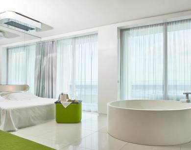 Modern room with bathtub, sea view.