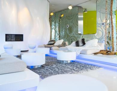 Modern living room with white sofas and futuristic decor.