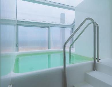 Indoor pool with panoramic view and natural light.