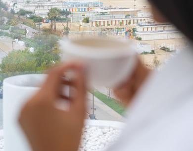 Sea view with a coffee cup in hand.