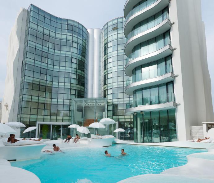 Modern hotel with pool and elegant architecture.