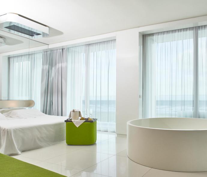 Modern room with bathtub, sea view.