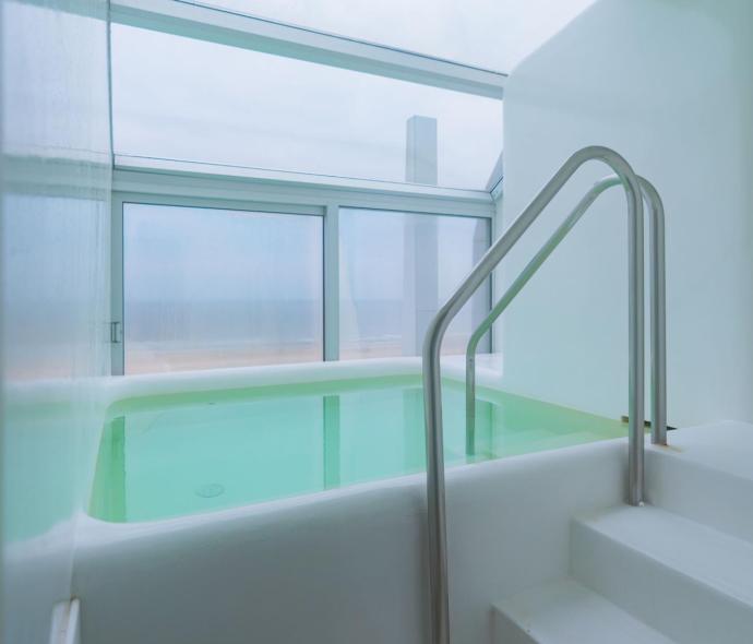 Indoor pool with panoramic view and natural light.