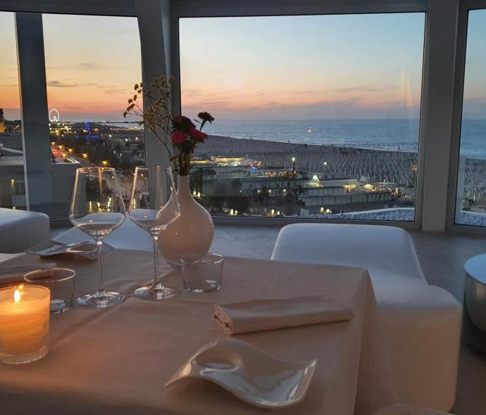 Romantic dinner with a sea view at sunset.