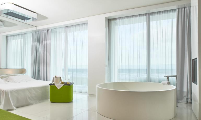 Modern room with bathtub, sea view.