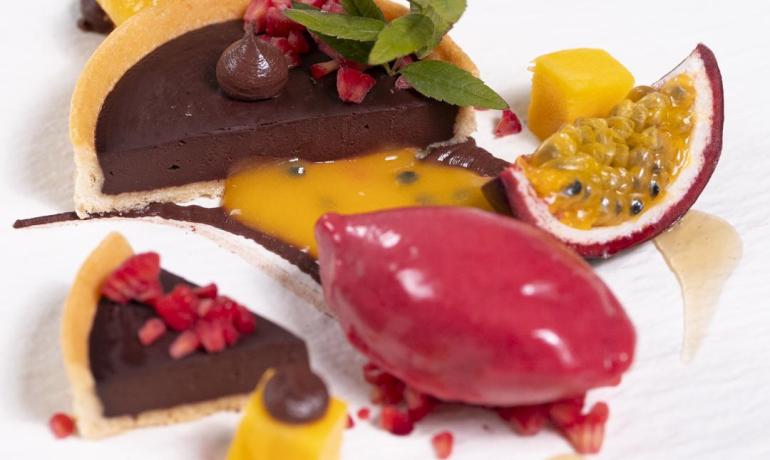 Dessert with chocolate, tropical fruits, and sorbet.