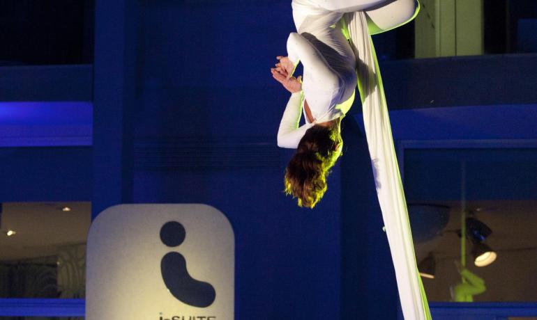 Acrobat in white suspended in air, magical and enchanting atmosphere.