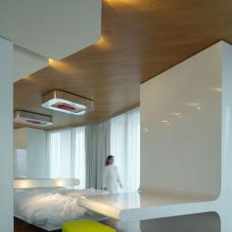 Modern room with futuristic furniture, soft lighting, and a serene atmosphere.